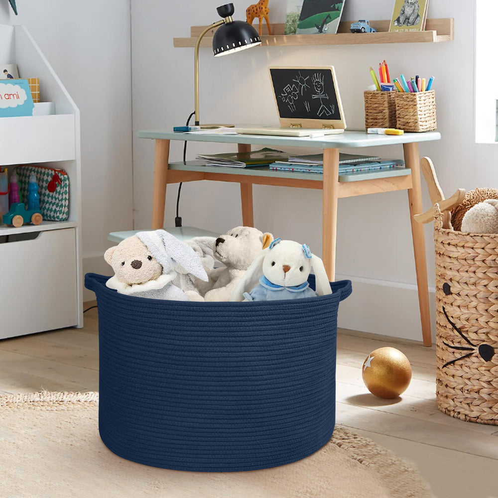 MEGASKET dark blue basket with blankets beside the sofa.