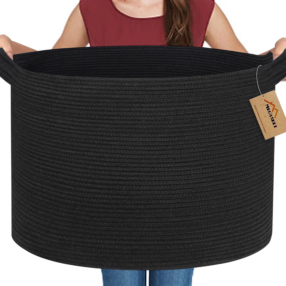 MEGASKET large black basket holds blankets and pillows for easy living room organization.