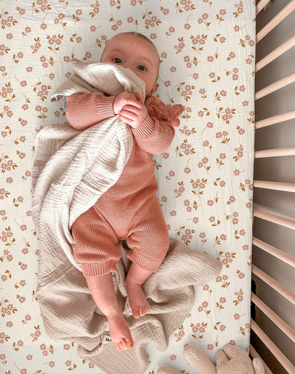 Meowcards bassinet sheet neutral floral pink blends with nursery decor.