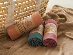 Meracorallo blanket shown as multi-use burp cloth and receiving blanket