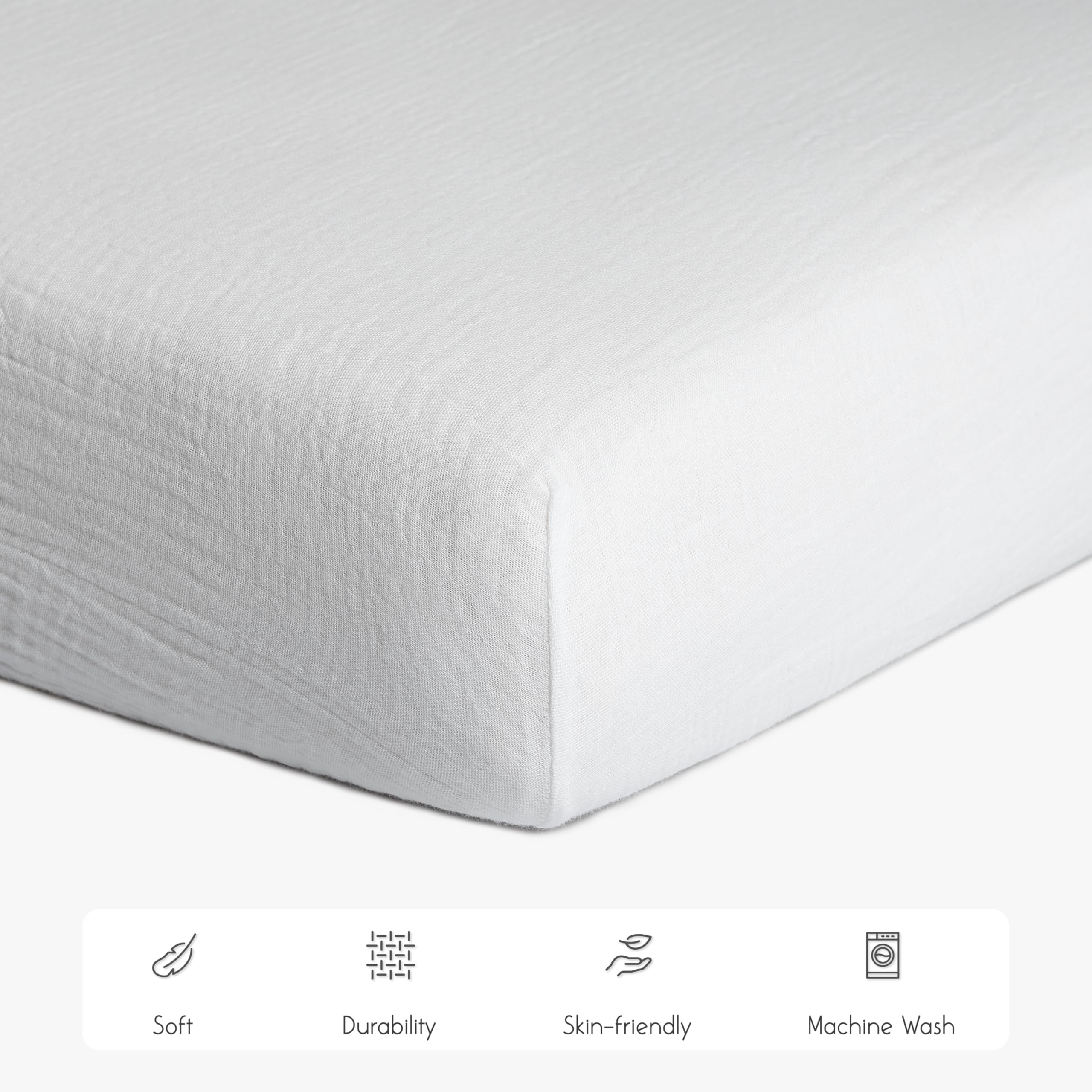 Meracorallo muslin crib sheet shows elastic edge for a secure, easy-to-change fit.