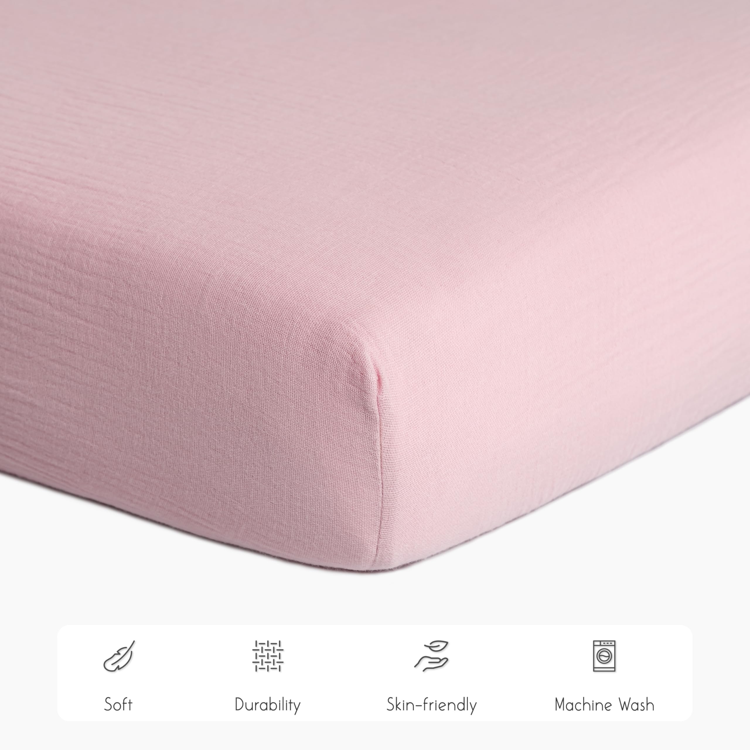 Meracorallo muslin crib sheet pink elastic edges for secure fit.