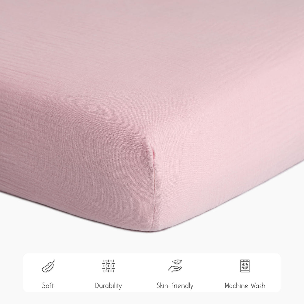 Meracorallo muslin crib sheet pink elastic edges for secure fit.