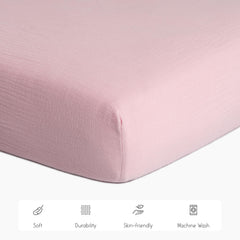 Meracorallo muslin crib sheet pink elastic edges for secure fit.