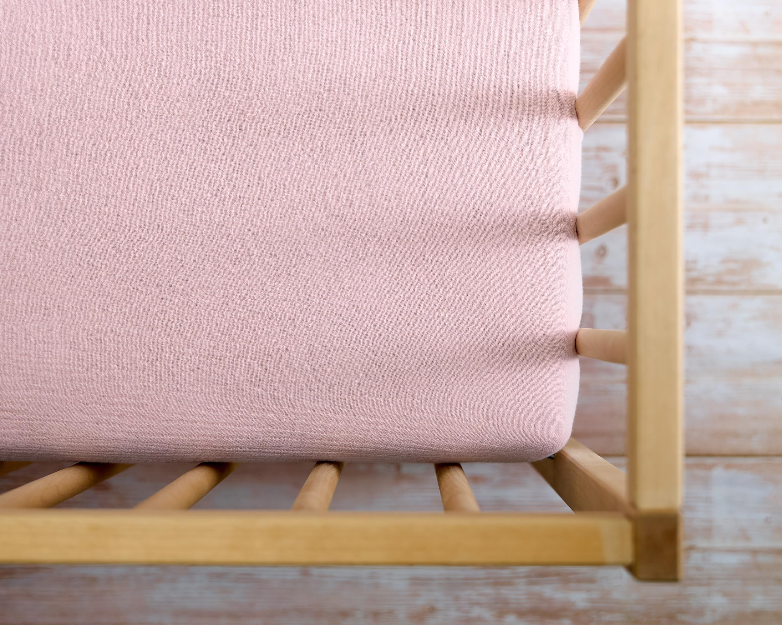 Meracorallo muslin crib sheet pink nursery styling in use.