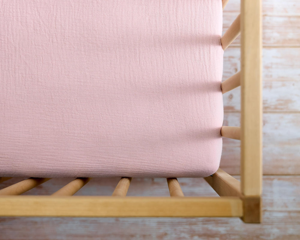 Meracorallo muslin crib sheet pink nursery styling in use.