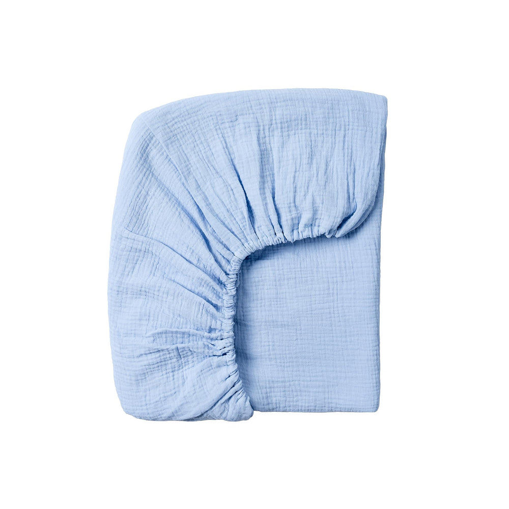 Meracorallo muslin crib sheet sky blue folded for soft, breathable comfort.