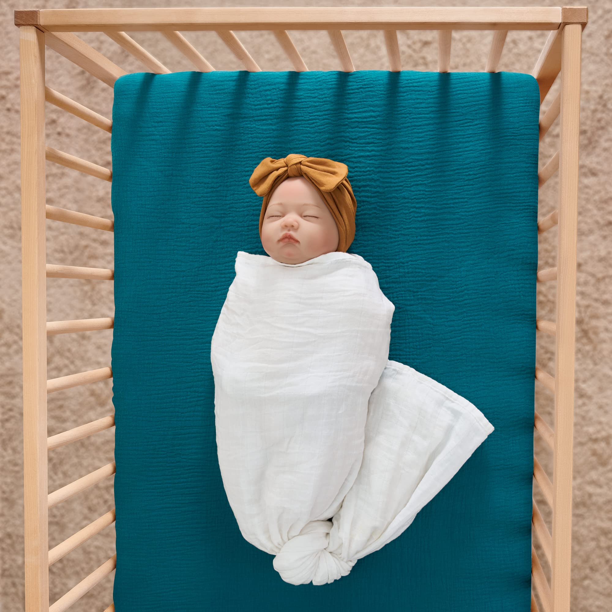 Meracorallo teal muslin crib sheet close-up showing pre-washed softness