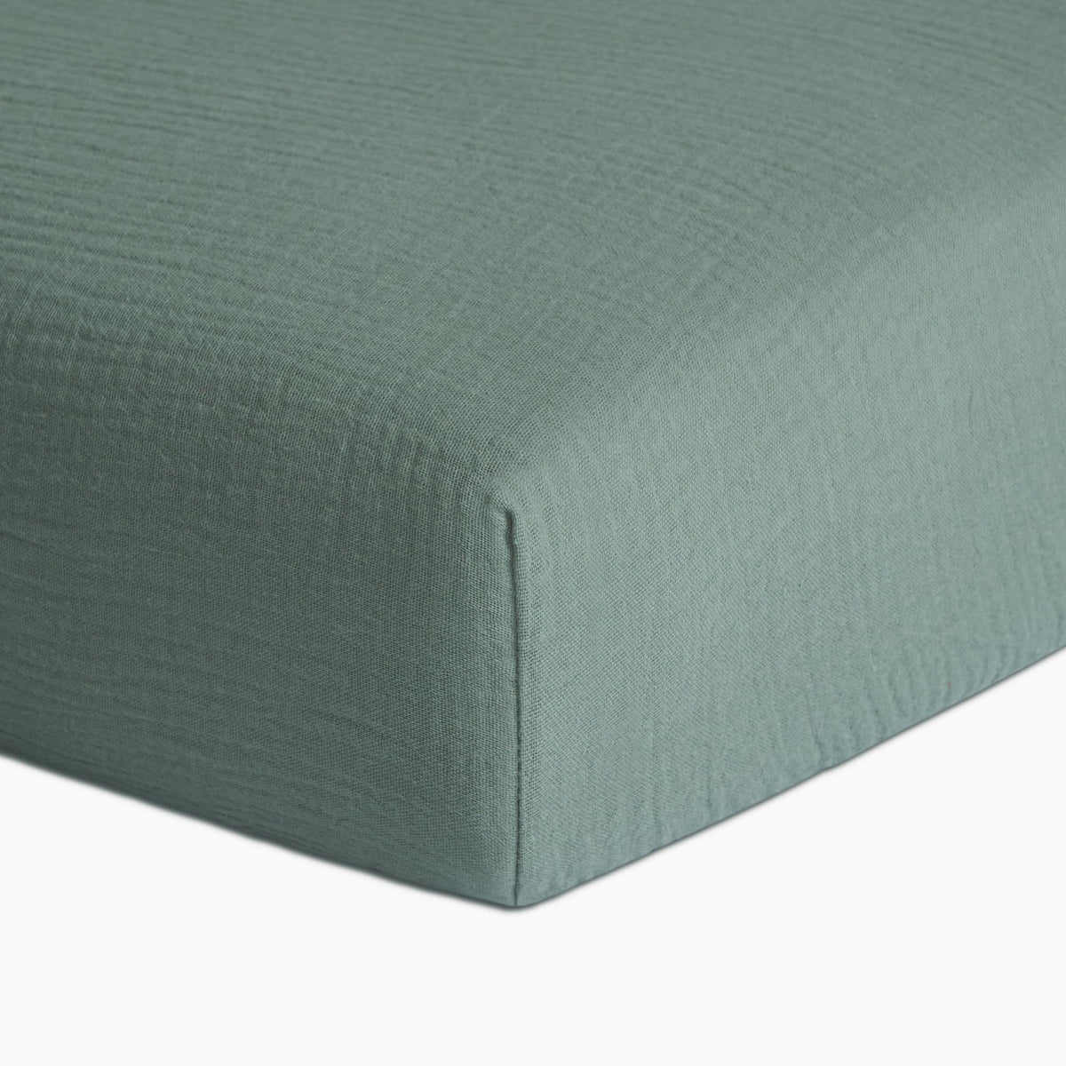 Meracorallo Roman Green muslin crib sheet close-up shows soft, breathable texture