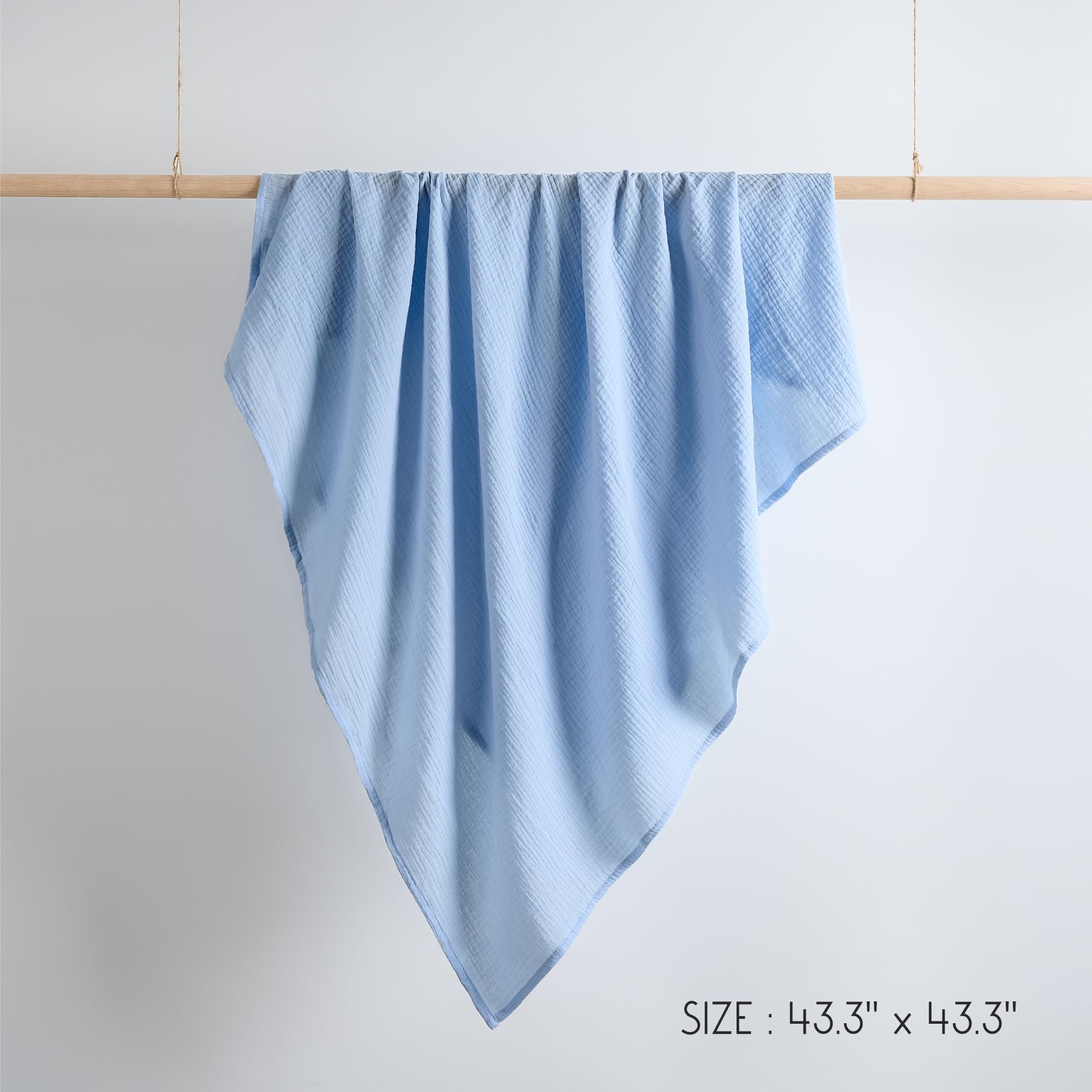 Nursery scene featuring Meracorallo Sky Blue muslin blanket as a cozy accessory.