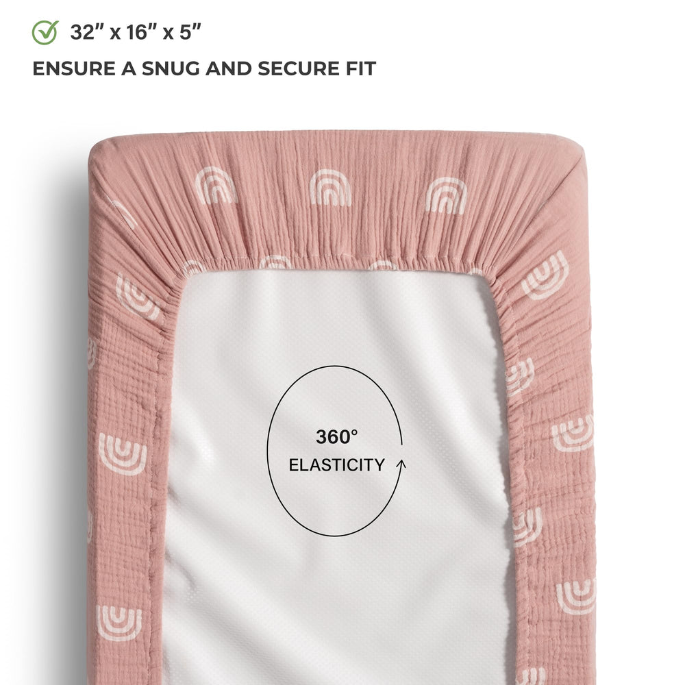 Meracorallo rainbow changing pad cover on mattress shows elastic edges for a snug fit.