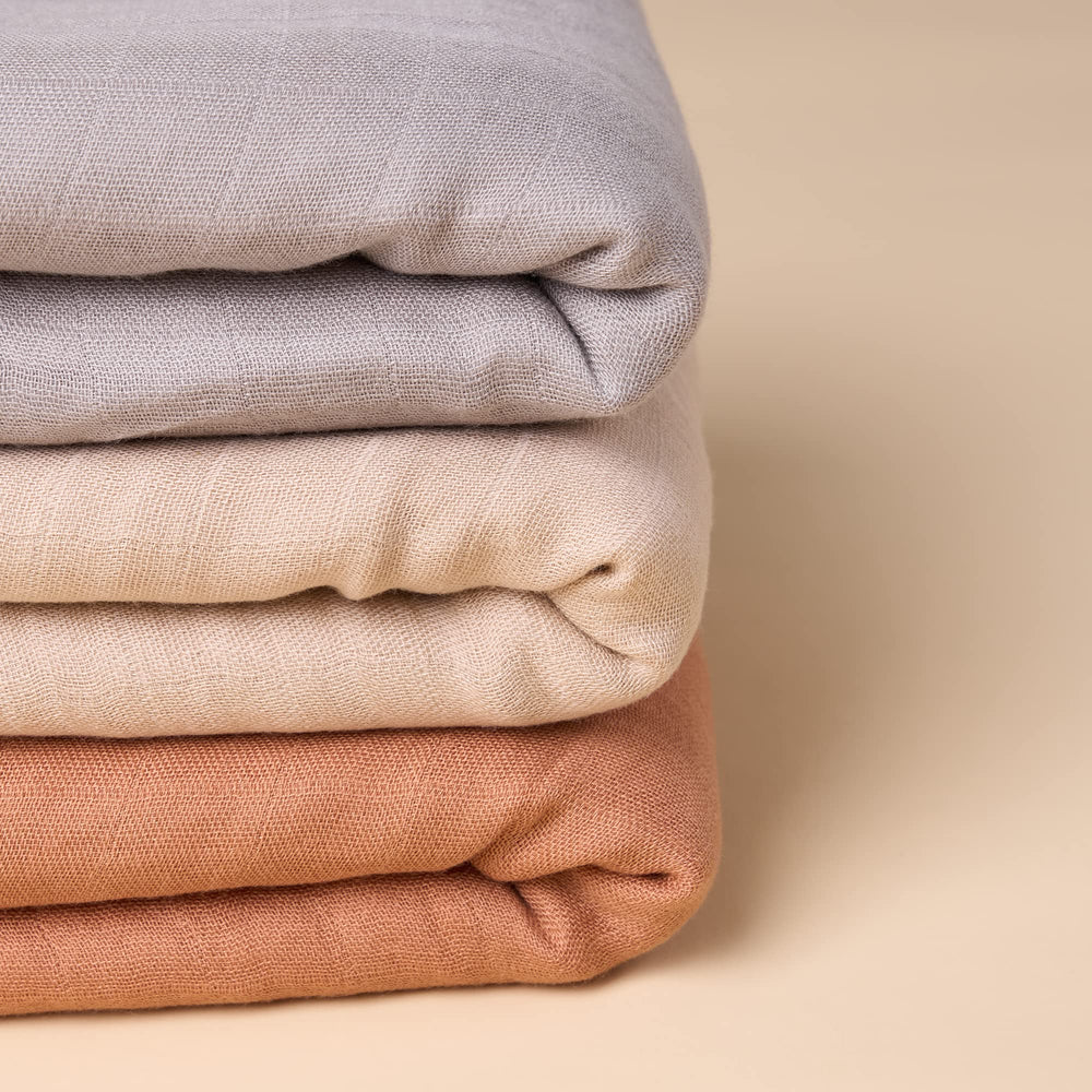 Meracorallo camel swaddle used on changing table or as a burp cloth alternative.