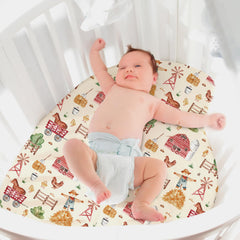 Mindsoft baby sleeping on farm-animal crib sheet in a cozy nursery