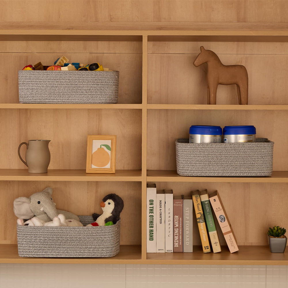 MiniArk organization bins add texture to mixed grey living room shelves.
