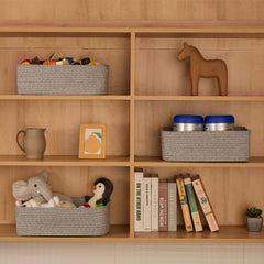 MiniArk organization bins add texture to mixed grey living room shelves.