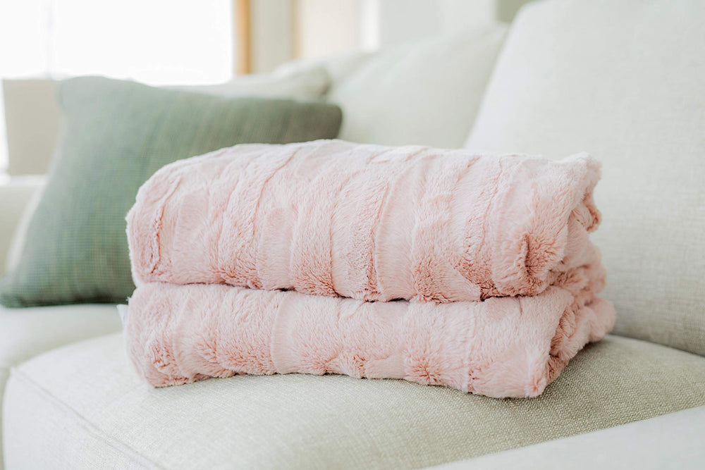 Minky Couture Sorbet Blanket draped in a living room for elegant décor.