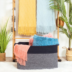 Mintwood Design rope basket with sturdy handles demonstrates easy transport around the home.
