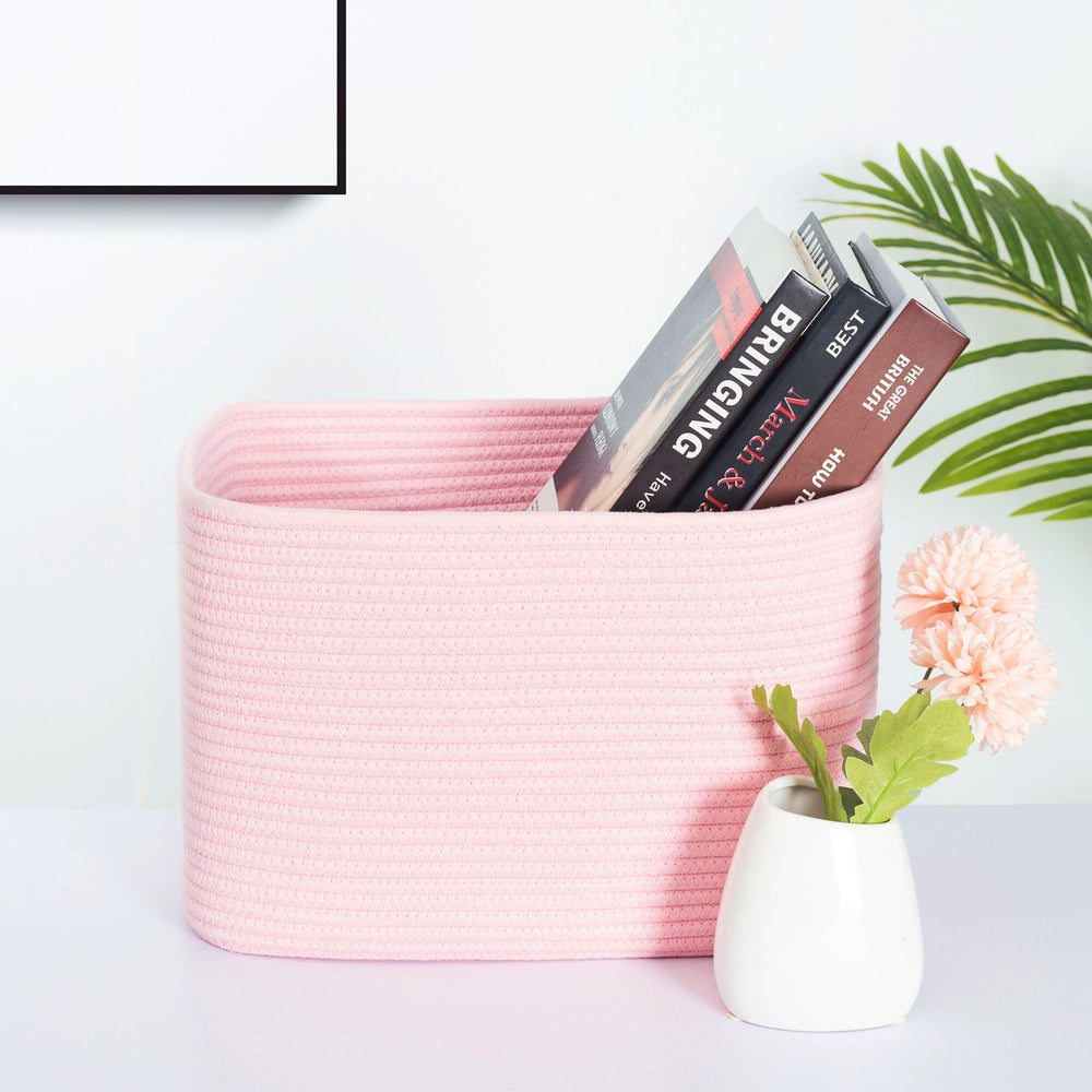 MINTWOOD Design woven cube bins organizing books on shelves.