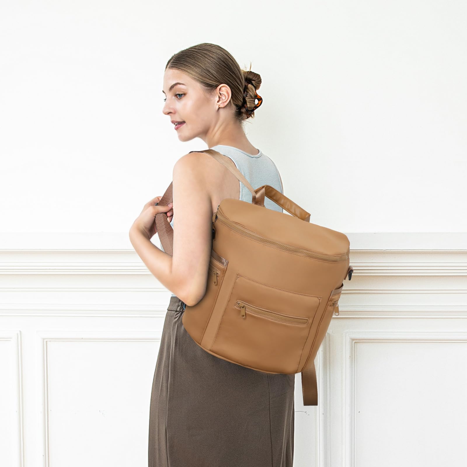 Back pocket of Miss Fong diaper bag doubles as luggage sleeve
