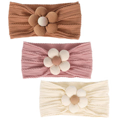 MIUXUESO baby flower headband yellow front view, soft stretch for newborn comfort