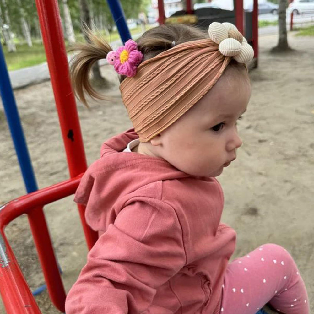 MIUXUESO flower headbands on a baby girl for charming photos and outfits.