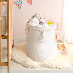 Mkono macrame basket stores toys and books for organized living spaces.