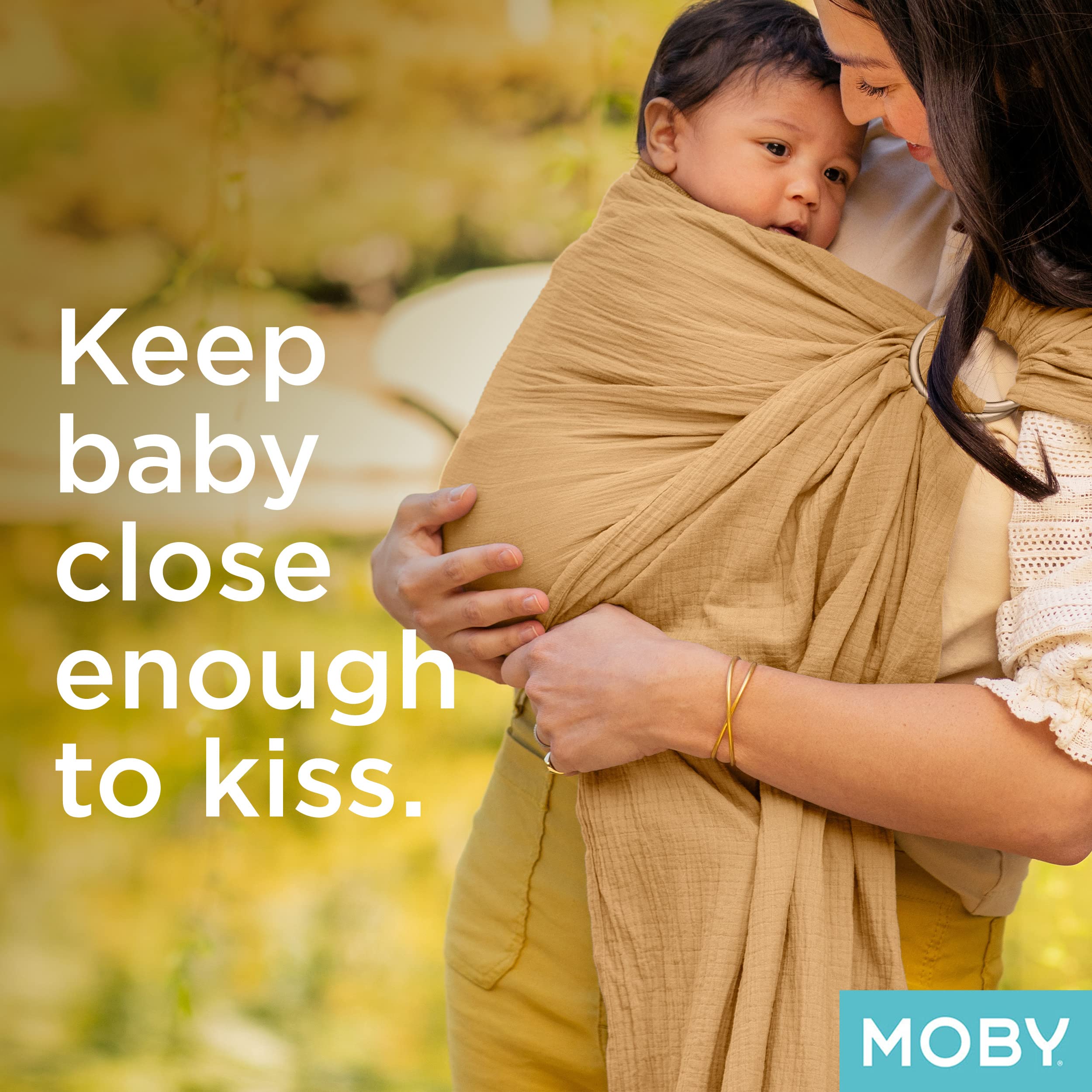 Stylish parents wearing Moby Ring Sling Rose during a family outing
