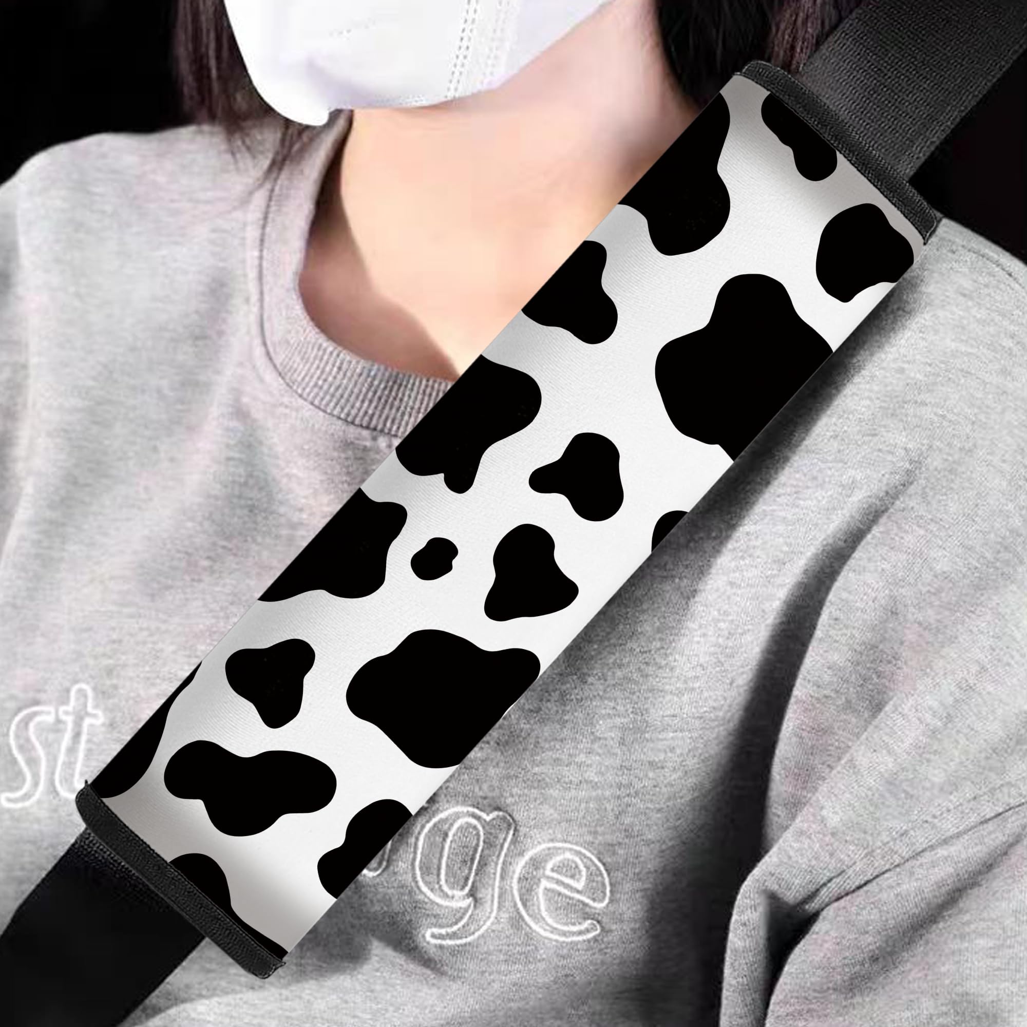 Mokiwala cow-pattern car seat belt pad side view showing cushioning and style.