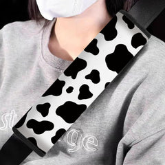 Mokiwala cow-pattern car seat belt pad side view showing cushioning and style.
