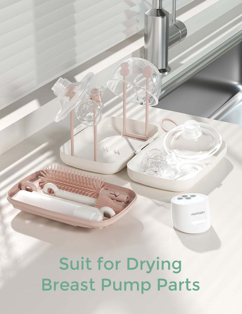 Momcozy bottle brush set in use with baby bottles on the counter.