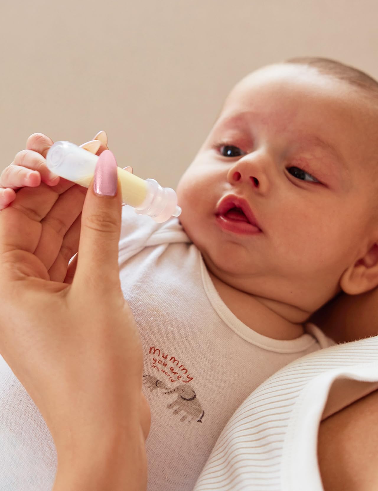 Momcozy colostrum collector nib closeup with precise suction design.