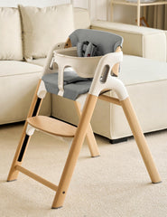 Momcozy high chair cushion backrest detail highlighting added lumbar support