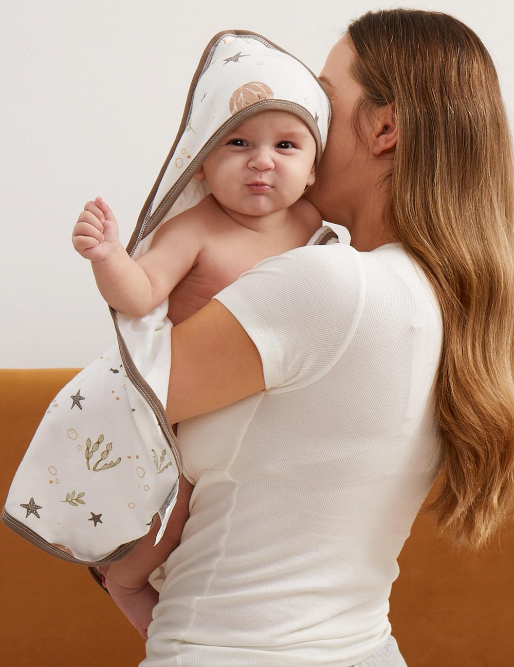 Momcozy towel size demonstration suggests full-body wrap from newborn to toddler.