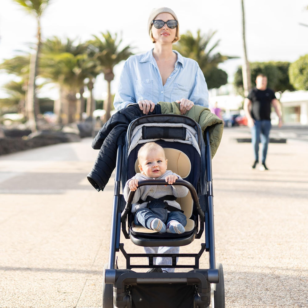 Momcozy in-use seat liner shown on a baby stroller for clean, dry seating.