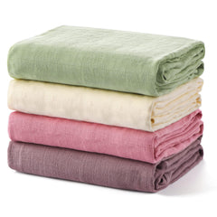 Momcozy muslin swaddle blanket soft texture closeup highlighting gentle, skin-friendly fabric.
