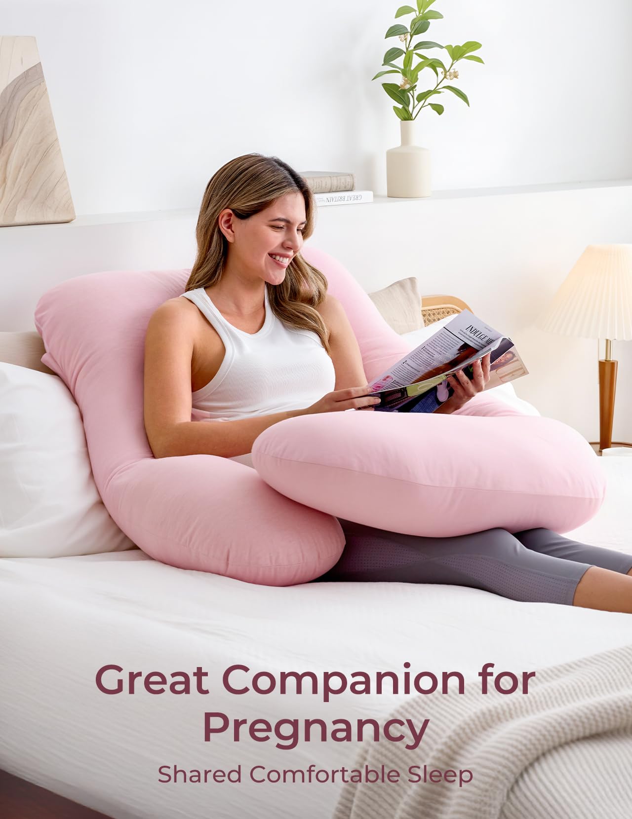 Momcozy pink belly-support pillow cradles belly to relieve pressure.