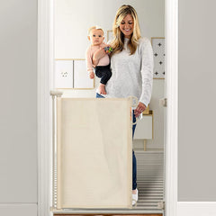 Momcozy retractable baby gate across a doorway, blocking access for safe play