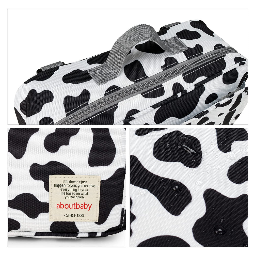 MOMIGO cow print diaper caddy used as a stroller bag for quick access on the go.