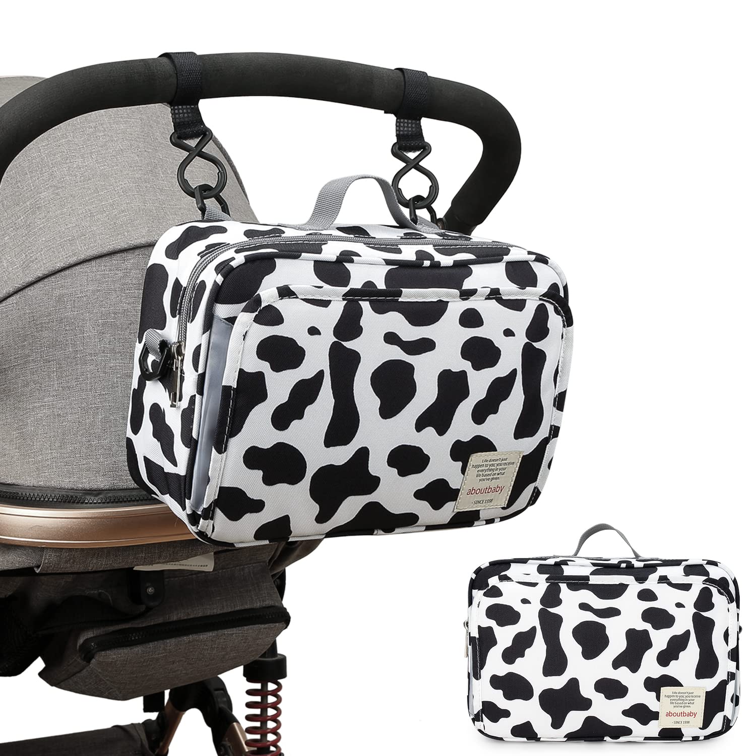 MOMIGO cow print diaper caddy cleaning using a soft brush for quick refreshment.
