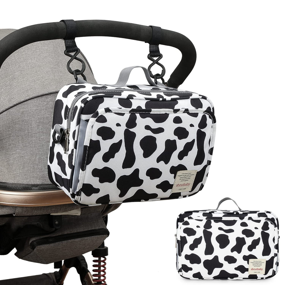 MOMIGO cow print diaper caddy cleaning using a soft brush for quick refreshment.