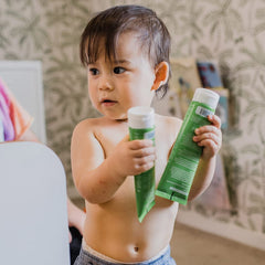 Application scene shows MooGoo gentle massage on baby or child skin.