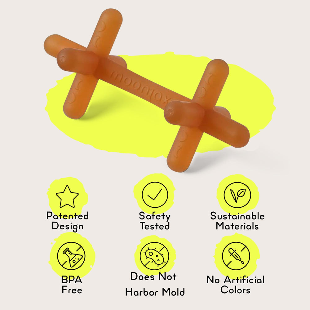 Moonjax teether on baby's gums offers gentle teething massage
