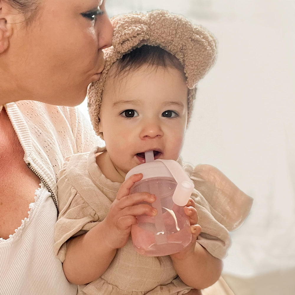 Moonkie Baby Straw Cup with lid attachment to prevent spills during travel.