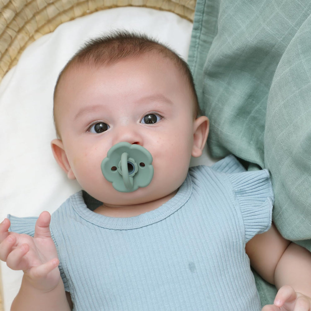Moonkie Daisy pacifier with scalloped edges offers gentle soothing and style.
