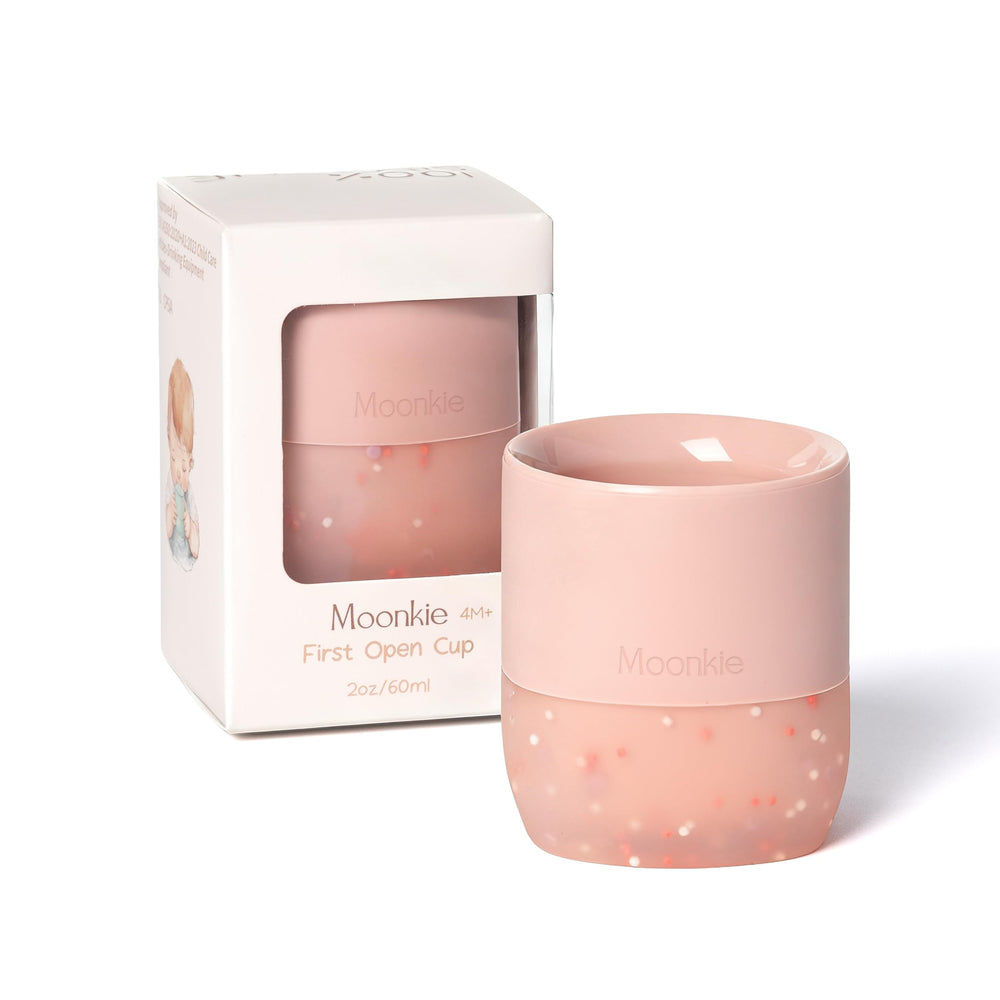 Moonkie silicone baby cup with confetti sprinkles supports independent sipping for tiny hands.