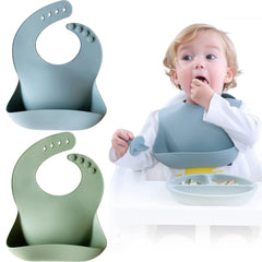 Moonkie silicone bib in ether-sage during mealtime shows large pocket catching spills