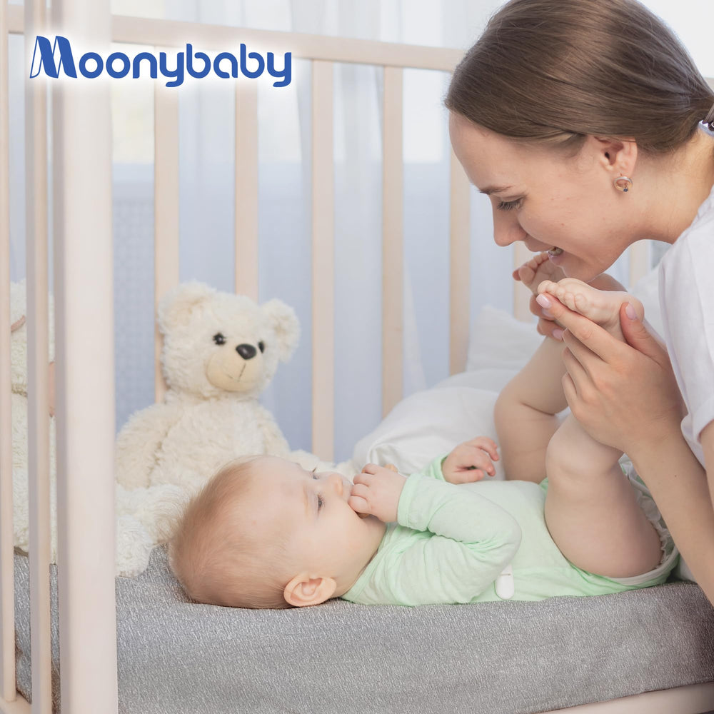 Calm nursery scene featuring Moonybaby sheet for a gentle bedtime routine.
