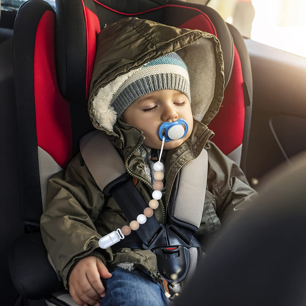 MORIBOX beige pacifier clip on clothing demonstrates secure everyday use