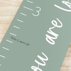 Morxy growth chart installation with sturdy string on sage canvas