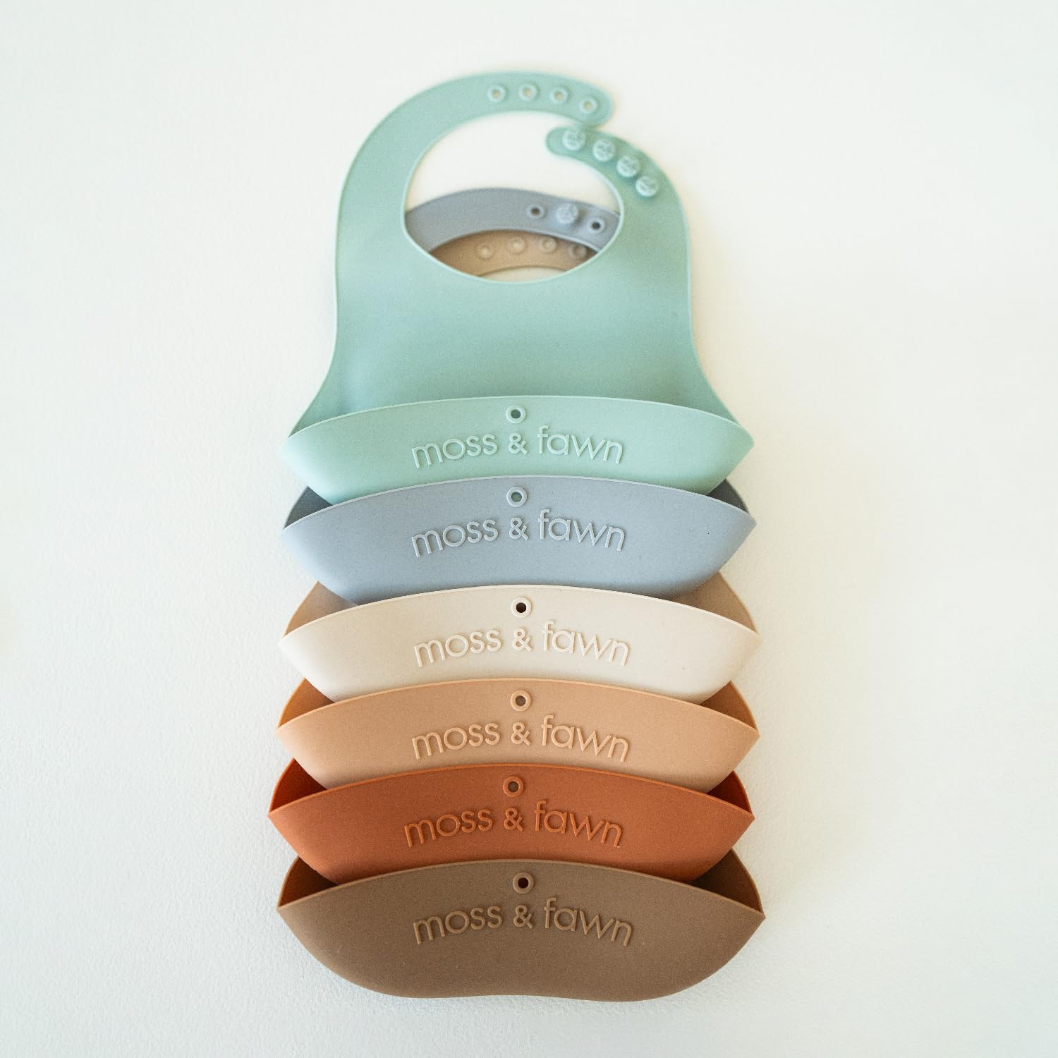 Moss and Fawn on-the-go bib folds compactly for diaper bag travel.